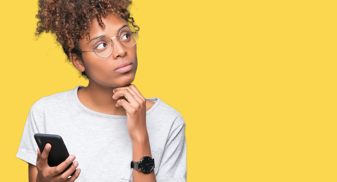 Girl contemplating a question with phone in hand