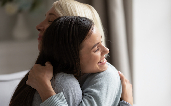 Two girls hugging and smiling