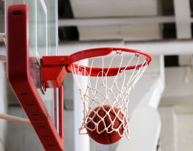 Basketball falling through net