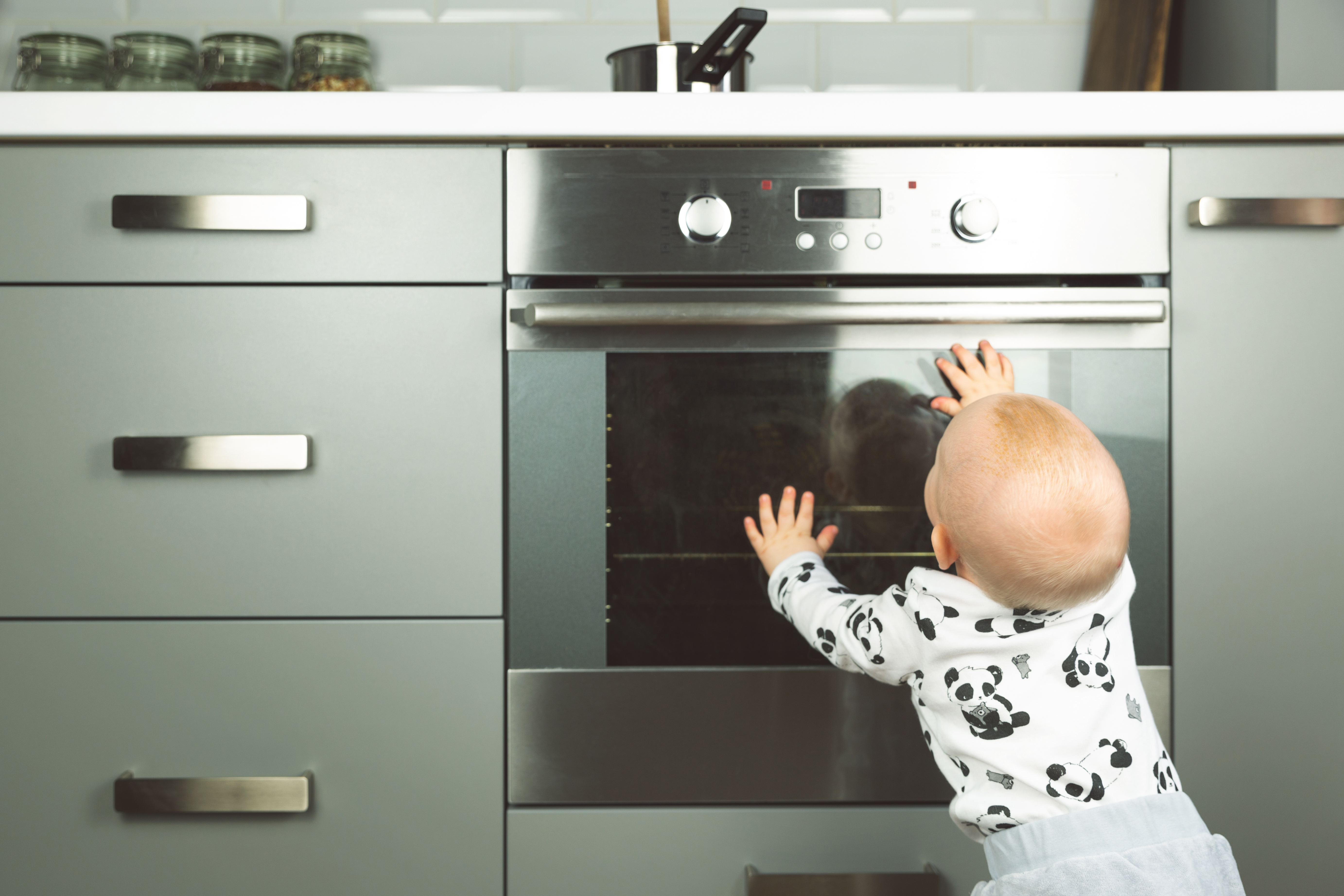 baby touching stove