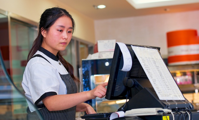 Young woman working at cashier